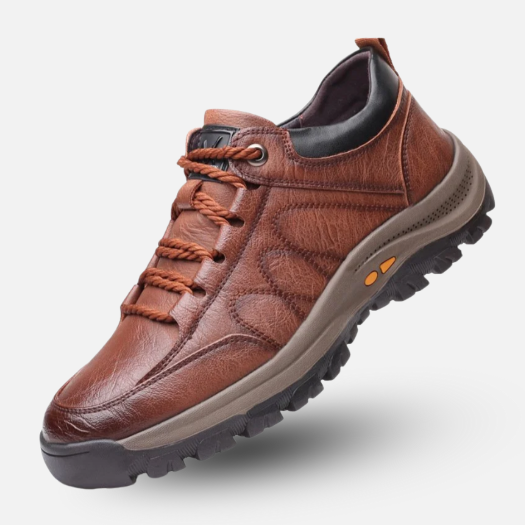 Brown leather shoe with orange laces on a white background