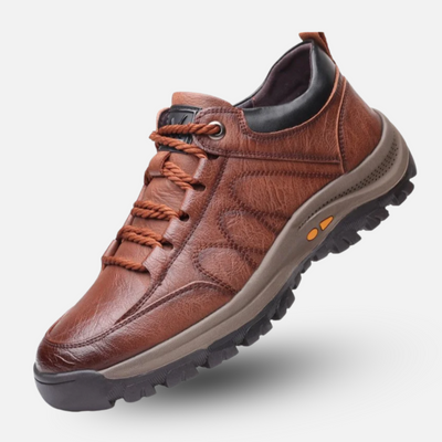 Brown leather shoe with orange laces on a white background