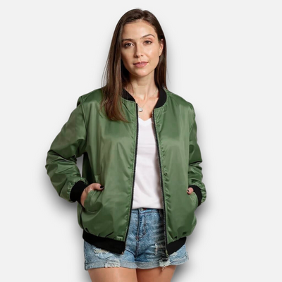 Woman wearing a green bomber jacket on a white background